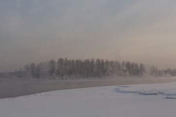 winter frosty sunset on the river in Siberia in winter