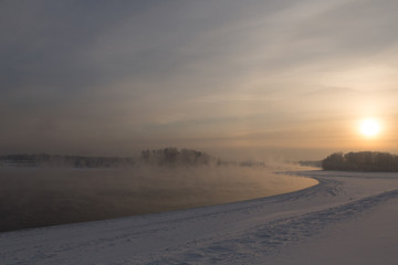 Fototapeta na wymiar winter frosty sunset on the river in Siberia in winter