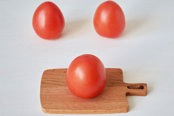 Close-up of fresh, ripe tomatoes on wood background