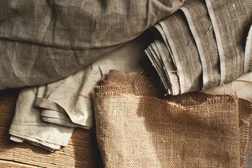 Wandcirkels tuinposter Natural fabrics from organic colors of flax and cotton in rolls, homespun textile handmade. Burlap and canvas for eco, rustic, boho, hygge decor © amixstudio