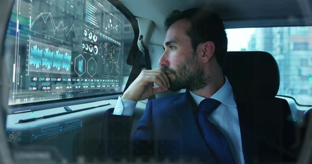 Slow motion of young handsome businessman in car using futuristic augmented reality hologram for viewing finance and economic trends. - Powered by Adobe