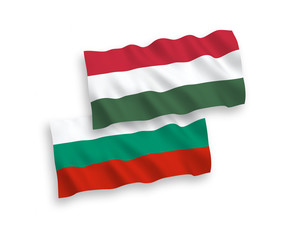 National vector fabric wave flags of Hungary and Bulgaria isolated on white background. 1 to 2 proportion.