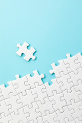 ジグソーパズル　White jigsaw puzzle on blue background - obrazy, fototapety, plakaty