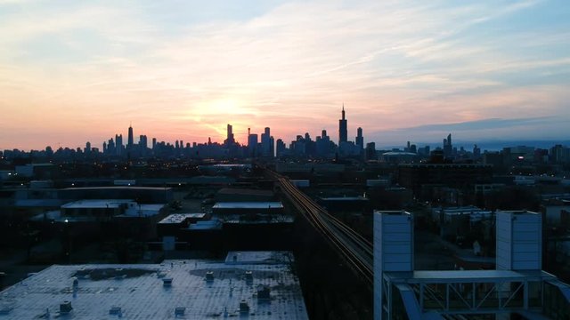 Chicago Illinois/United States March 29th 2019: drone footage of an urban community near downtown Chicago over by the CTA Train stop. a complete view of the Chicago skyline during sunrise 