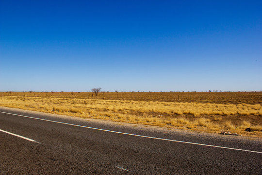 traight road in the dessert of Australia on the Flinders Hightway, Quennsland Australia