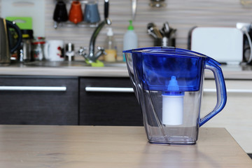 Filter for cleaning drinking water on the table in the kitchen. Purification of drinking water at...