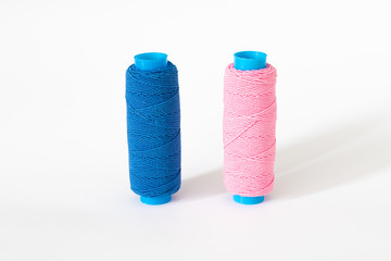 Two thread bobbin isolated on a white background