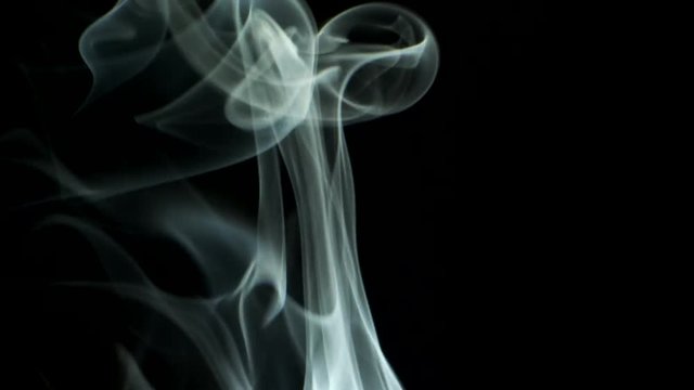 Trickle smoke slowly rising graceful twists upward. Cigar smoke blowing from bottom to top. Natural color tobacco smoke. Great for editing, video without color correction and grading, 4K - 60fps