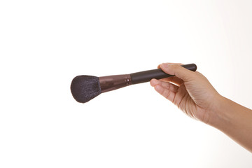 make up artist hand hold the blush on brush