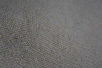 Light soft fabric with a fine weave texture, beige and cream fleecy background