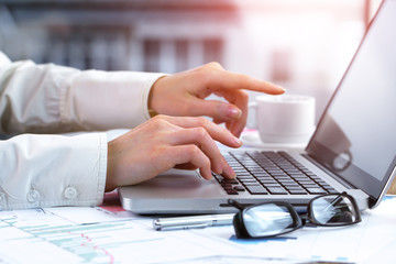 Women's hands with items for business on the table