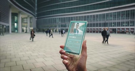 Slow motion of a business woman hand using a futuristic glass cellphone with the latest advanced augmented reality holographic technology to make video call to her colleague. - Powered by Adobe