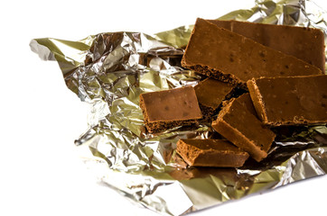 milky, porous chocolate on a white background