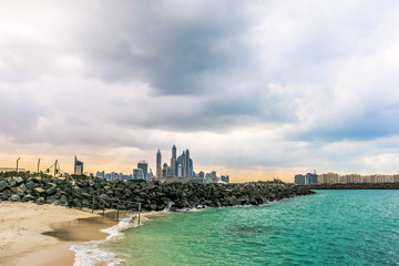 Fototapeta premium Horizon of Seascape, water waves at Jumeirah Beach under cloudy sky in Dubai, United Arab Emirates