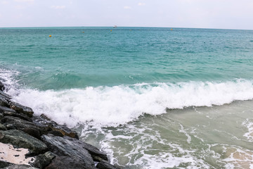 Horizon of Seascape, water waves at Jumeirah Beach under cloudy sky in Dubai, United Arab Emirates
