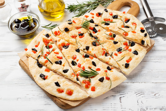 Focaccia With Rosemary , Black Olives And Chopped Tomatoes.