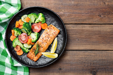 Fototapeta na wymiar Baked salmon fillet with broccoli and vegetables mix.