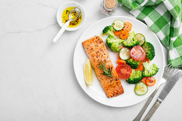 Baked salmon fillet with broccoli and vegetables mix.