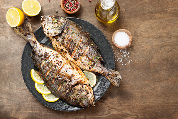 Delicious baked dorado or sea bream fish with lemon .
