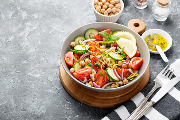 Salad of chickpeas, tomatoes, cucumbers and greens. Dietary food. Vegan salad.