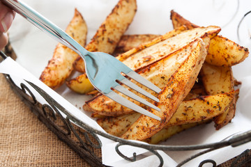 Baked potato wedges on basket - homemade organic vegetable, vegan potato wedges snack food meal