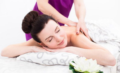 Obraz na płótnie Canvas Beautiful brunette at the reception of a massage therapist