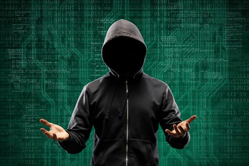 Anonymous computer hacker over abstract digital background. Obscured dark face in mask and hood. Data thief, internet attack, darknet fraud, dangerous viruses and cyber security.