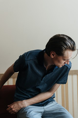 A man in a blue polo poses for menswear advertising. Shooting for men's clothing store