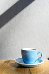 Espresso coffee  in blue ceramic cup on wooden table background.