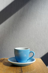 Espresso coffee  in blue ceramic cup on wooden table background.