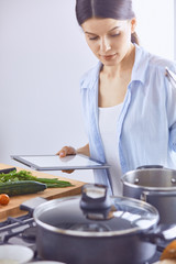 A young woman prepares food in the kitchen. Healthy food - vege