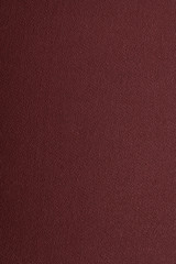 Maroon texture background, abstraction. Space for text. Matte coating