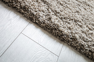 carpet high pile of threads of different thicknesses and weaving on the wooden floor. Shaggy carpet...