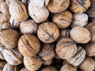 Walnut in a shell on a counter of shop. Useful and nutritious nut