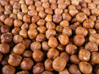 The peeled hazelnut. It is a lot of filbert on a counter of shop. Useful, nutritious product