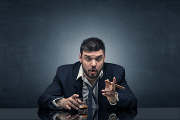 Young drunk man at his office with free dark copyspace