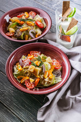 Easy Vegetable salad from zucchini, ice lettuce, red onions and parmesan cheese. Vegetarian healthy and tasty food. Diet and healthy lunch