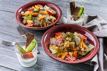 Close-Up Easy Vegetable salad from zucchini, ice lettuce, red onions and parmesan cheese. Vegetarian healthy and tasty food. Diet and healthy lunch