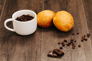 cup of coffee with bread   on wooden table