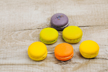 Cake macaron or macaroon on turquoise background from above, colorful almond cookies, pastel colors, vintage card, top view 