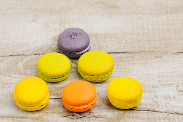 Cake macaron or macaroon on turquoise background from above, colorful almond cookies, pastel colors, vintage card, top view 