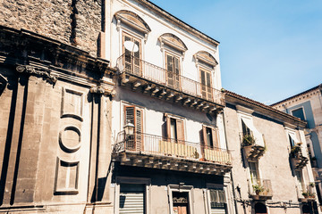 Entrance door, facade of old baroque building in Catania, traditional architecture of Sicily, Italy.