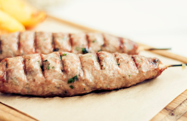 grilled minced meat with herbs, traditional Greek lunch in a restaurant.