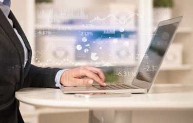 Business woman in homey environment using laptop with financial report concept
