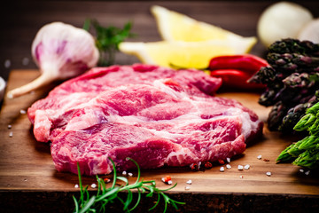 Fresh raw beef steaks on cutting board