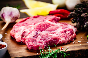Fresh raw beef steaks on cutting board