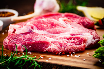 Fresh raw beef steaks on cutting board