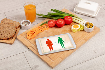 Arrangement of healthy Ingredients with a tablet. Dieting concept