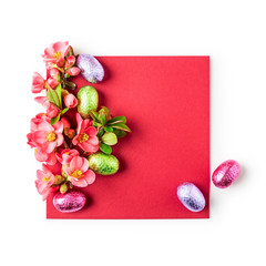 Easter greeting card with candy eggs and japanese quince