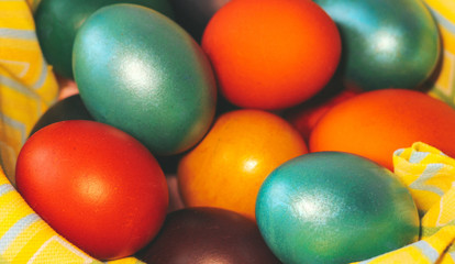Fototapeta na wymiar Multicolored painted eggs in the basket close up.